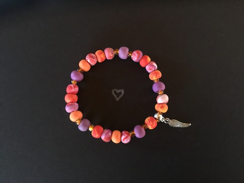 Visual response to the beautiful sunset following Nova Scotia Shooting. The colours in this bracelet represent God's masterpiece in the sky on April 20th, and the angel wing represents all the beautiful souls taken from us.